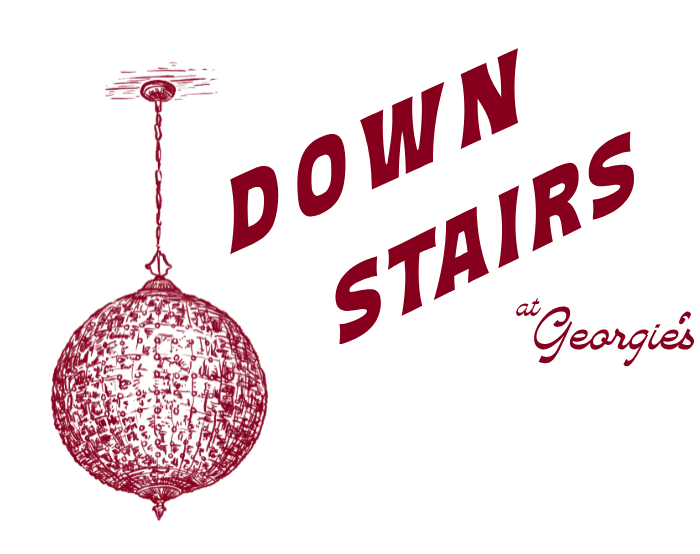 Down Stairs at Georgie's — a red disco ball hanging beside the words Down Stairs at Georgie's